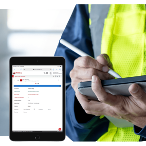 Facility technician using CMMS software on tablet to manage building maintenance tasks