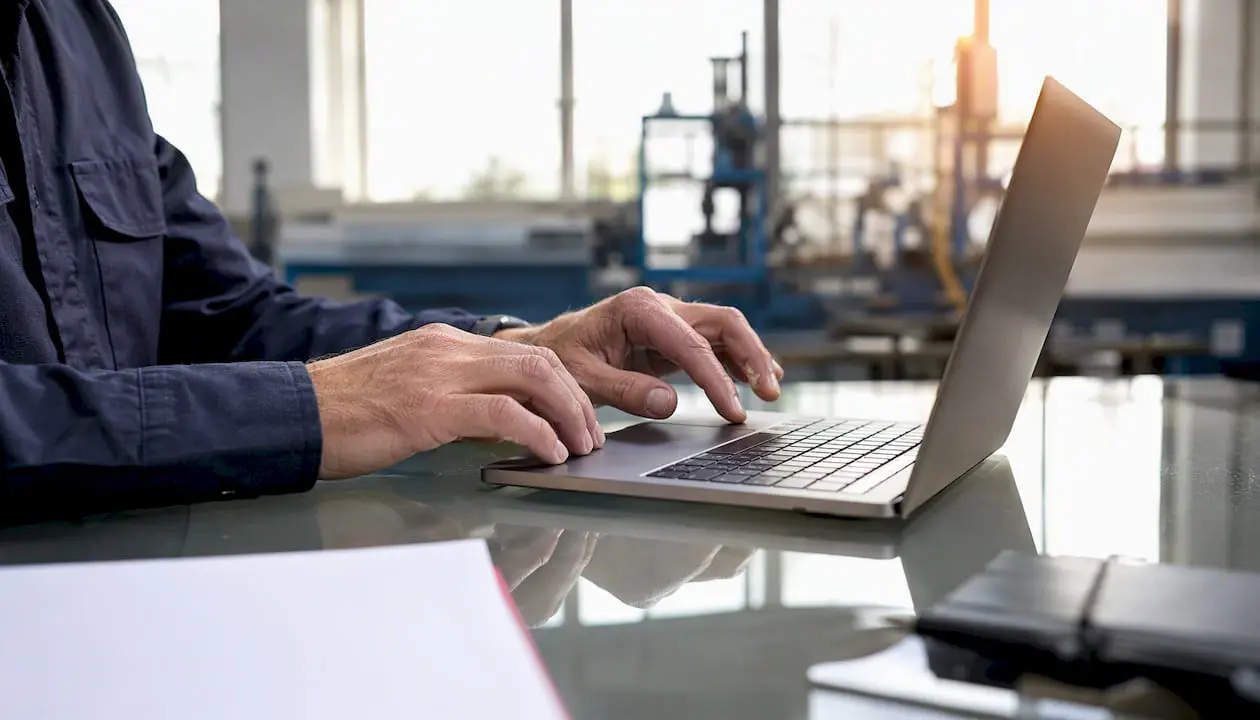 Hands organizing contractor compliance files