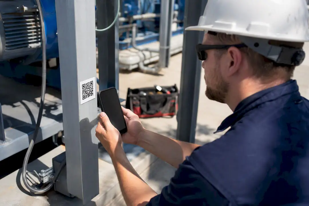 Technician scanning QR code on machine