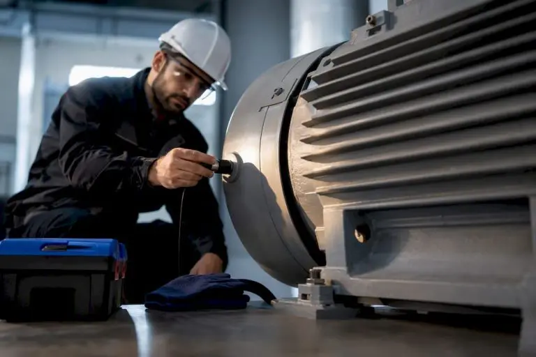 Technician measuring industrial motor vibration