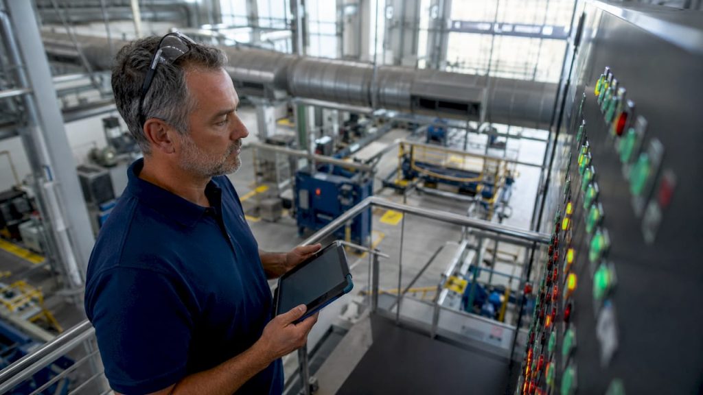 Facility manager monitoring assets in control room