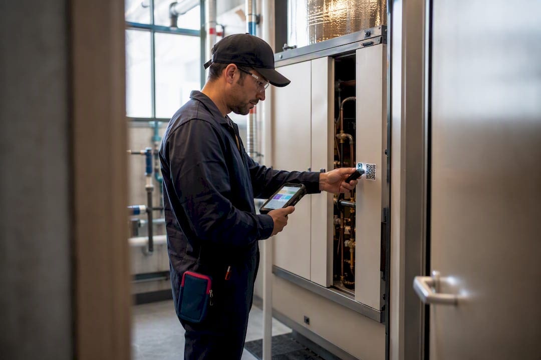 Technician scanning QR code during maintenance